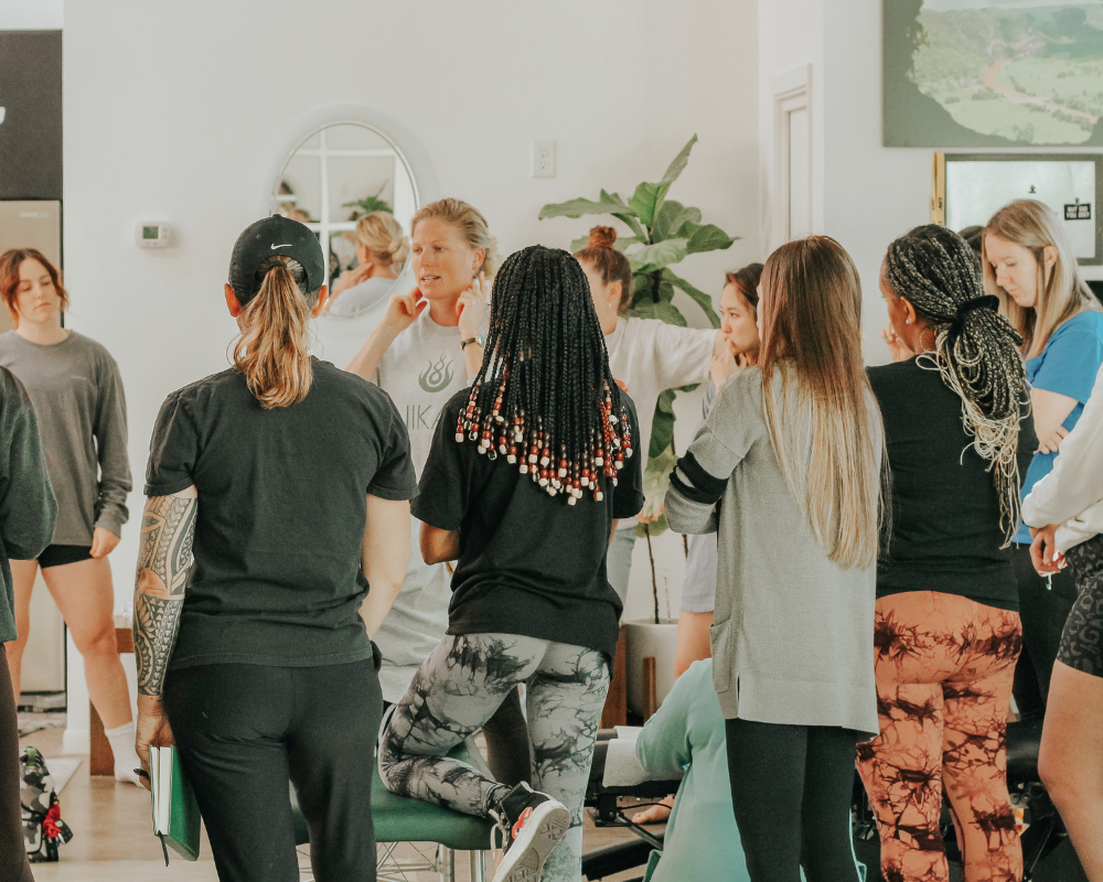 Dr. Lauren presenting an adjusting seminar to a group of women.